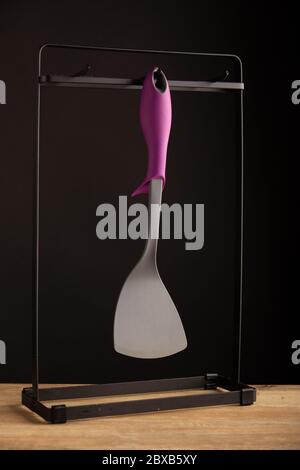 A plastic spatula for a meal on a black background Stock Photo