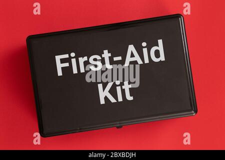 First-Aid kit isolated on a red background Stock Photo