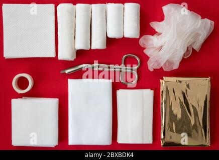 Insides of a first aid kit isolated on a red background Stock Photo