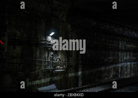 Empty underground train tunnel. Dark close-up subway station. Malaga, Spain - March 3, 2020. Stock Photo