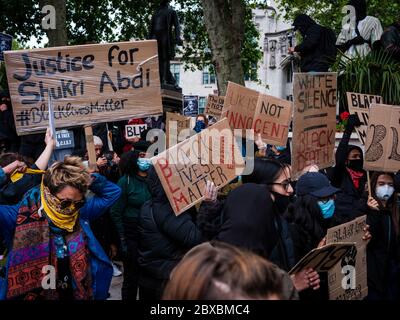 London, UK. 6th June, 2020. Protestors hold placards during the Black Lives Matter Protest in Parliament Square in London.  In memory of George Floyd who was killed on the 25th May while in police custody in the US city of Minneapolis. Credit: Yousef Al Nasser/Alamy Live News. Stock Photo