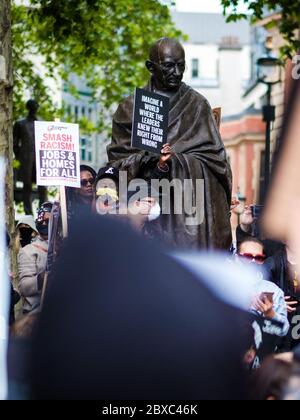 London, UK. 6th June, 2020. Protesters gather around the statue of Ghandi at the Black Lives Matter Protest in Parliament Square in London.  In memory of George Floyd who was killed on the 25th May while in police custody in the US city of Minneapolis. Credit: Yousef Al Nasser/Alamy Live News. Stock Photo