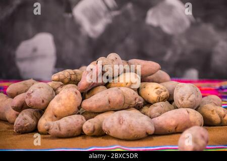 Andean products in the foreground, colored blanket and dark background Stock Photo