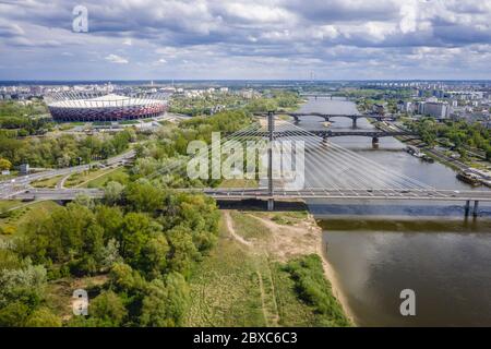 Aerial view in Warsaw city, Poland with Vistula River, Swietokrzyski Bridge and National Stadium Stock Photo