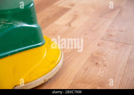 Application of oil-based floor finish on luxury oak parquet with a polish machine, which tends to enhance the appearance of parquet Stock Photo