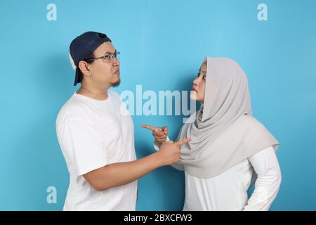 Portrait of Asian muslim couple husband and wife having fight, argue on each other, bad relationship in marriage concept