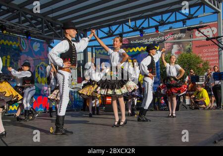 Slovakian dancers group called 'Jurosik' perform traditional Slovakian dance on stage in traditional costumes called 'Kroj'. Stock Photo