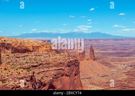 Canyon and Washer Woman Arch near Mesa Arch in Canyonlands National Park with La Sal Mountains at the background, Moab, Utah, USA. Stock Photo