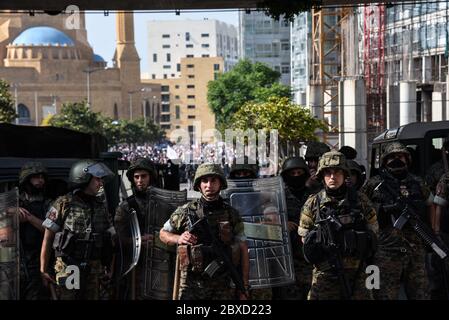 Beirut, Lebanon. 6th June, 2020. Army personel hold back Amal and Hezbollah supporters to avoid clashes with pro-revolution protersters as peaceful protest turned violent with protesters demanding early elections, an independent judiciary and the removal of the current government clashing with anti-revolution protesters. Both sides clashed with police and army forces. Credit: Elizabeth Fitt/Alamy Live News Stock Photo