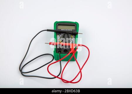 Digital electric tester multimeter. Digital multimeter with probes on a white background. Stock Photo