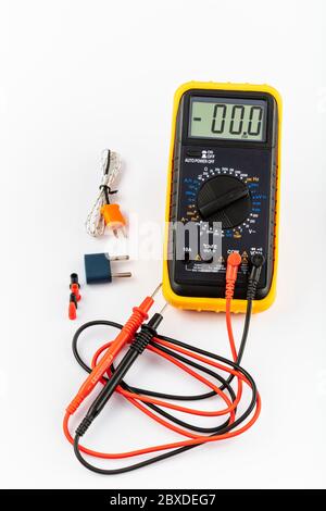 Multimeter for a measurement of a voltage, current and resistance with cables. Digital multimeter to check the resistance on a white background. Stock Photo