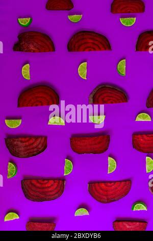 Beetroot in the form of a pattern with lemon slices on a purple background Stock Photo