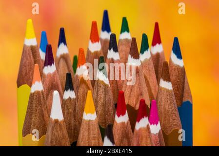 Top view on multi colored pencils rotating on white background. Close-up view on bright colored pencils for drawing in motion. colour pencils Stock Photo