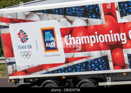 Aldi Championing Great British Quality; Red white & blue Haulage delivery trucks, lorry, transportation, truck, cargo carrier, Scania vehicle, European commercial transport, industry, M6 at Manchester, UK Stock Photo