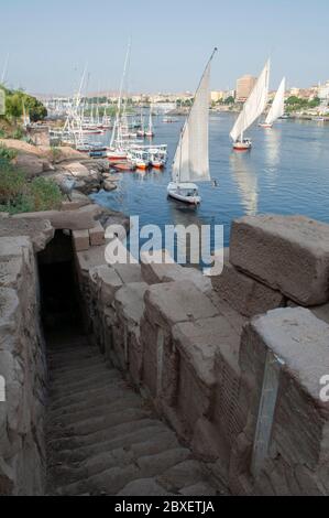 The stairway which leads down to a doorway of the ancient Nilometer of the Satet or Satis Temple built in late Ptolemaic or early Roman times for measuring the Nile River's clarity and water level during the annual flood season located on the Nile Valley island of Elephantine, forming part of the city of Aswan Egypt Stock Photo