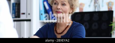 Doctor measures the pressure an elderly woman. Stock Photo