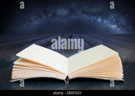 Conceptual composite open book image of Beautiful image of lavender field with Milky Way in lcear sky Stock Photo