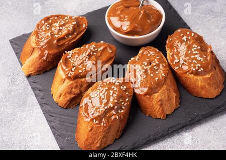 Sandwiches with baguette of bread spread with sweet paste of boiled condensed milk. Stock Photo