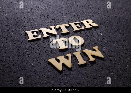 Enter to win, Questions and Answers. Motivational internet business words quotes, wooden lettering typography concept on black background Stock Photo