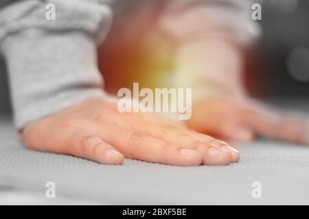 Close up of athletes hands doing push ups, body weight training to exercising chest, shoulder and triceps muscle, dramatic image with sunlight Stock Photo