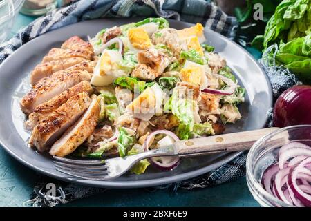 Healthy caesar salad with chicken, eggs, cheese and croutons. Italian cuisine Stock Photo
