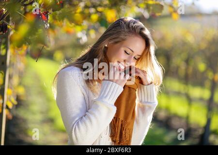 Smiling woman enjoying autumn sun in the countryside Stock Photo