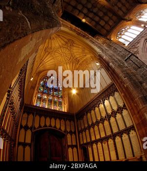 Looking up from the nave into the West Tower of Manchester Cathedral with its vaulted ceiling. Lists of Manchester dignatories regale the three walls. Stock Photo