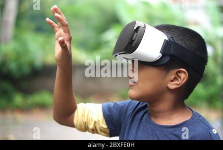Boy wearing VR device, surprised on the virtual reality Stock Photo