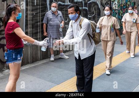 Alcohol spray for hand cleaning at free food kitchen during Covid pandemic, Bangkok, Thailand Stock Photo
