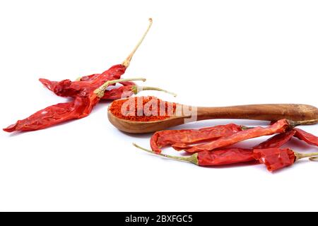 Red chili powder in wooden spoon on white background Stock Photo
