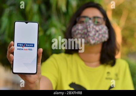 Mumbai, India, 2020. Girl wearing mask showing Swiggy Food ...