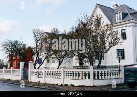 House on the corner of the street, with a beautiful white fence with columns in Reykjavik, the capital of Iceland. Stock Photo