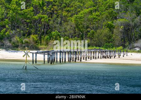 The remains of the MacKenzies Landing timber loading jetty, North White Cliffs, Fraser Island, Queensland Australia Stock Photo