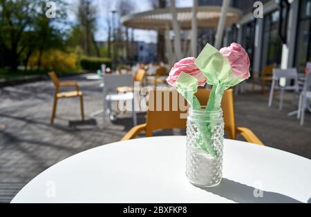 Paper flowers on the table in outside cafe Stock Photo