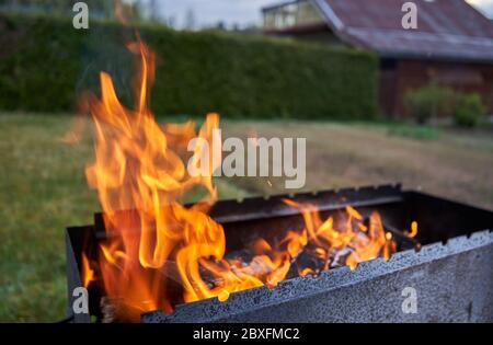 Fire in the fireplace in the garden Stock Photo