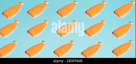 Several orange containers for cosmetics without label on blue background Stock Photo