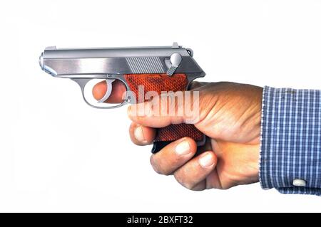 The small silver pistol in hand on the white background Stock Photo