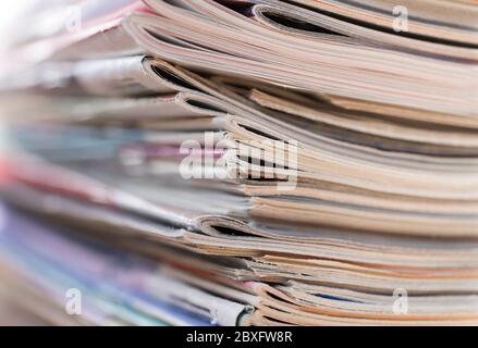 Stack of older slightly worn books colored magazines with narrow depth of field Stock Photo