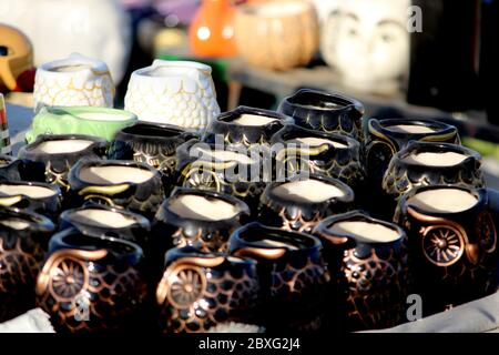 colorful pottery with traditional artwork, water pot Sculpture Made with Earthen Mud, handcrafted traditional clay decoration toy in indian market Stock Photo