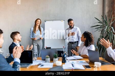 Business Team Applauding After Successful Startup Presentation In Modern Office Stock Photo