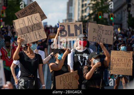 Protesters carry signs during a march against police brutality and racism in Washington, DC on Saturday, June 6, 2020.Credit: Amanda Andrade-Rhoades/CNP /MediaPunch Stock Photo