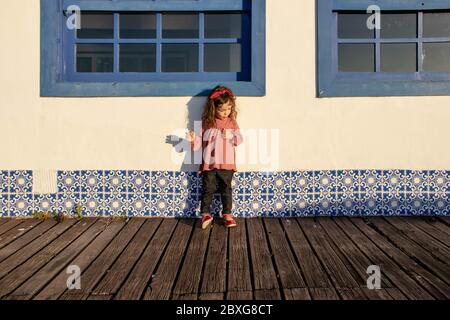 Girl standing on a wooden boardwalk, Armacao dos Buzios, Rio de Janeiro, Brazil Stock Photo