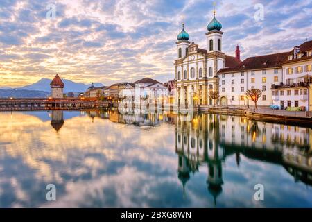 Lucerne Old town, Switzerland, view of the Reuss river, Chapel bridge and Jesuit church in dramatic sunrise light Stock Photo