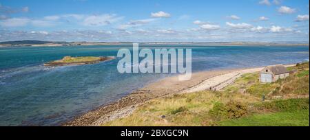 Panoramic view from Lindisfarne past St. Cuthbert's Island towards the Northumberland coast at high tide Stock Photo