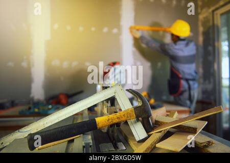 Construction engineer measuring a wall on a construction site Stock Photo
