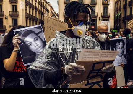 Barcelona, Spain. 7th June, 2020. A protestor reads the names of black victims during a protest against racism and police brutality during a tribute to Afro-American citizen George Floyd who was killed while being restrained by Minneapolis police. Credit: Matthias Oesterle/Alamy Live News Stock Photo
