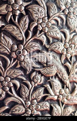 Silverware is carved by hand in a pattern of flowers and birds. Stock Photo