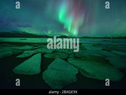 Northern lights over Diamond beach and Jokulsarlon at night, South central Iceland, Iceland Stock Photo