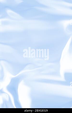 Blue liquid shiny background.  Wavy satin elegance light texture. Stock Photo