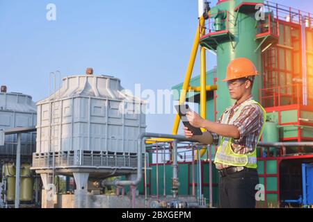 Engineer at a power plant using a digital tablet, Thailand Stock Photo